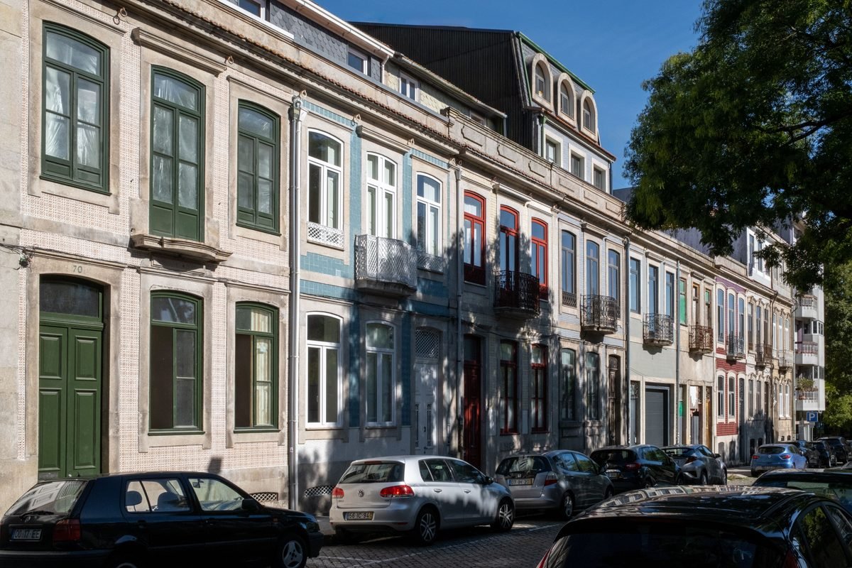 Charming colorful historical row houses along a street in Porto.