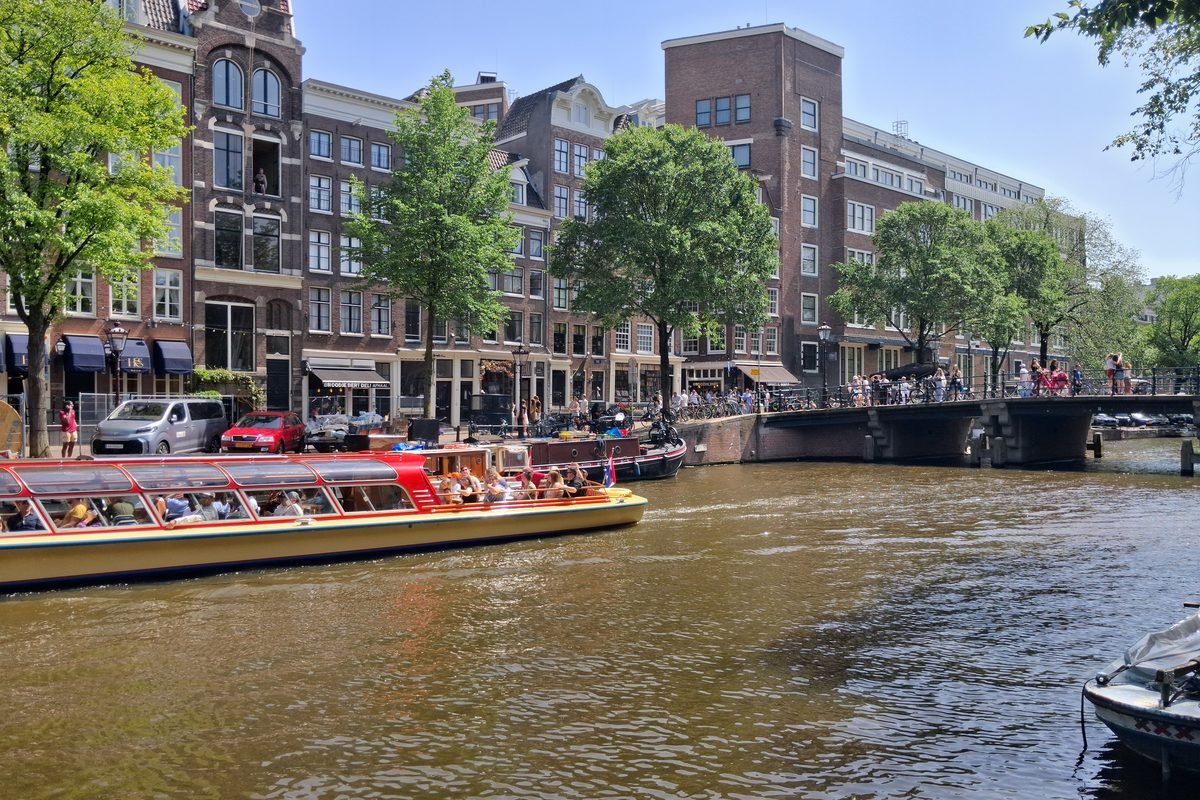 Tour boats navigating a city waterway.
