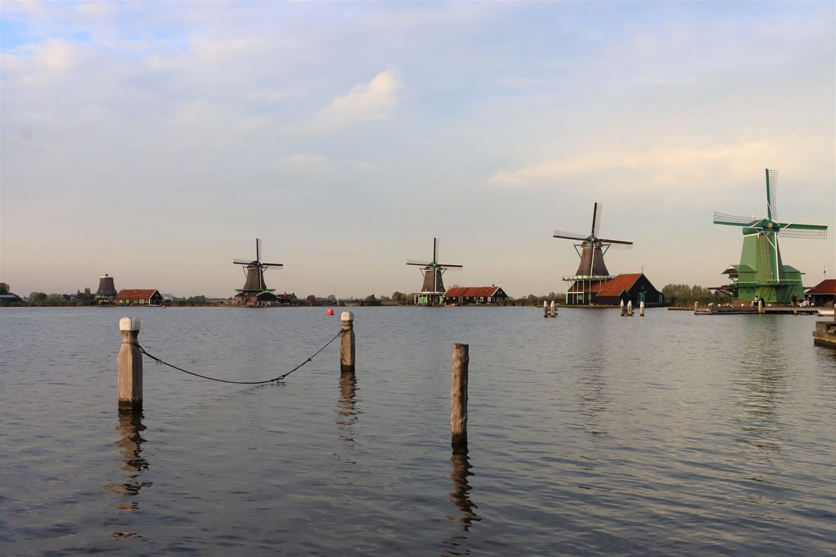 Traditional Dutch windmills along the water at Zaanse Schans.