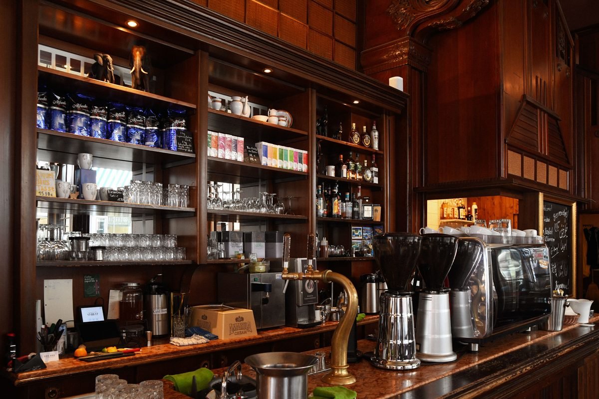Coffee shop counter with an espresso machine and equipment.