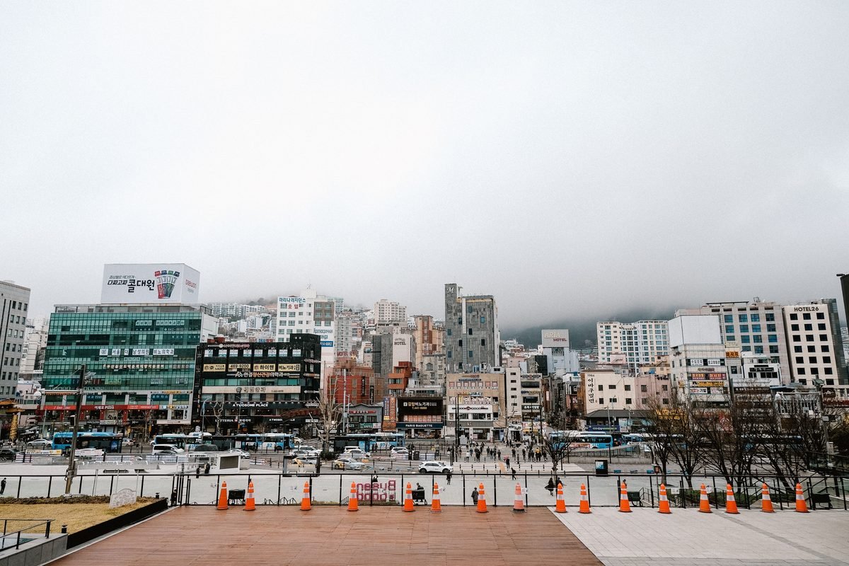 Street view of a South Korean city with commercial buildings and traffic.