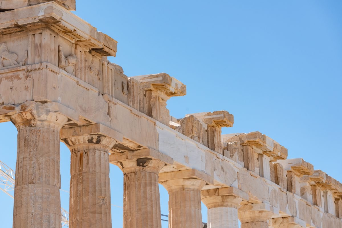 Close-up of ancient stone architectural details against a blue sky