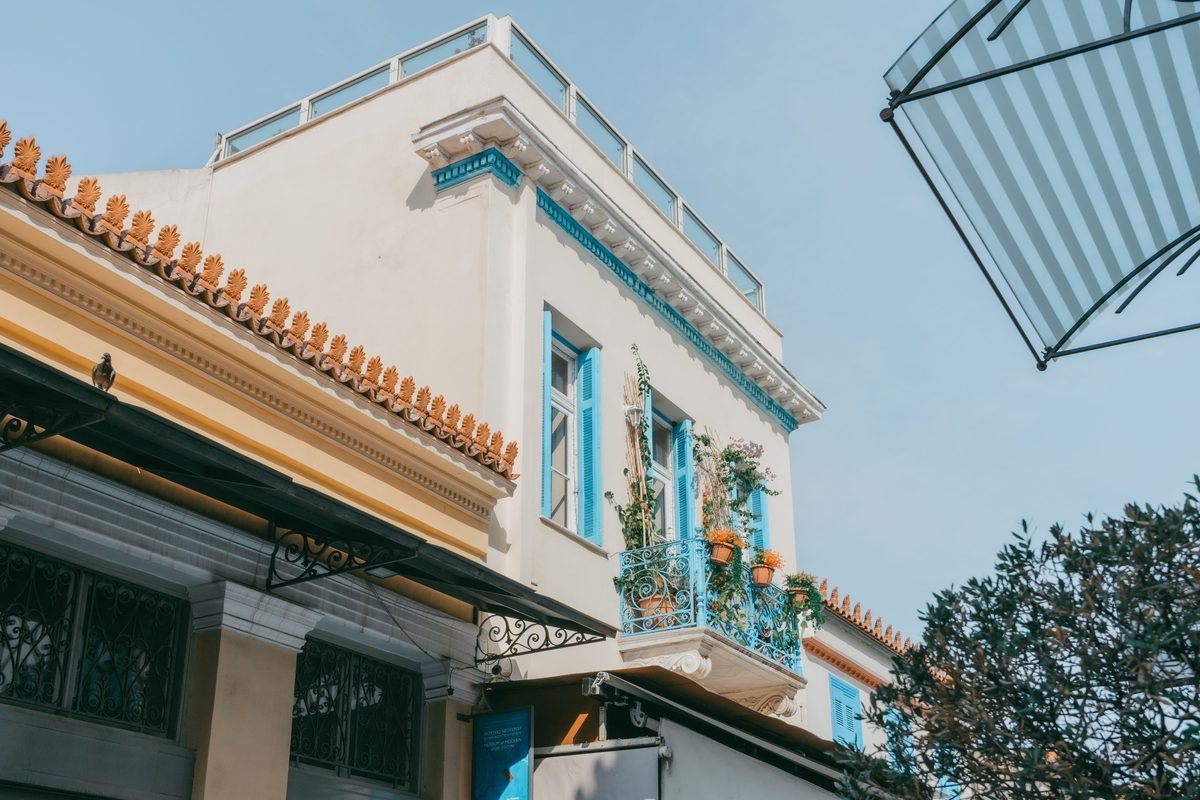 Traditional building with vibrant blue shutters and balcony