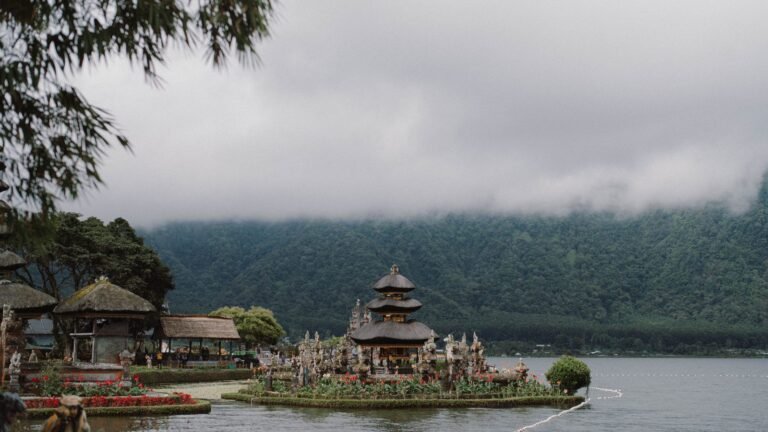 Traditional multi-tiered Balinese temple situated on the edge of a calm lake in Bali