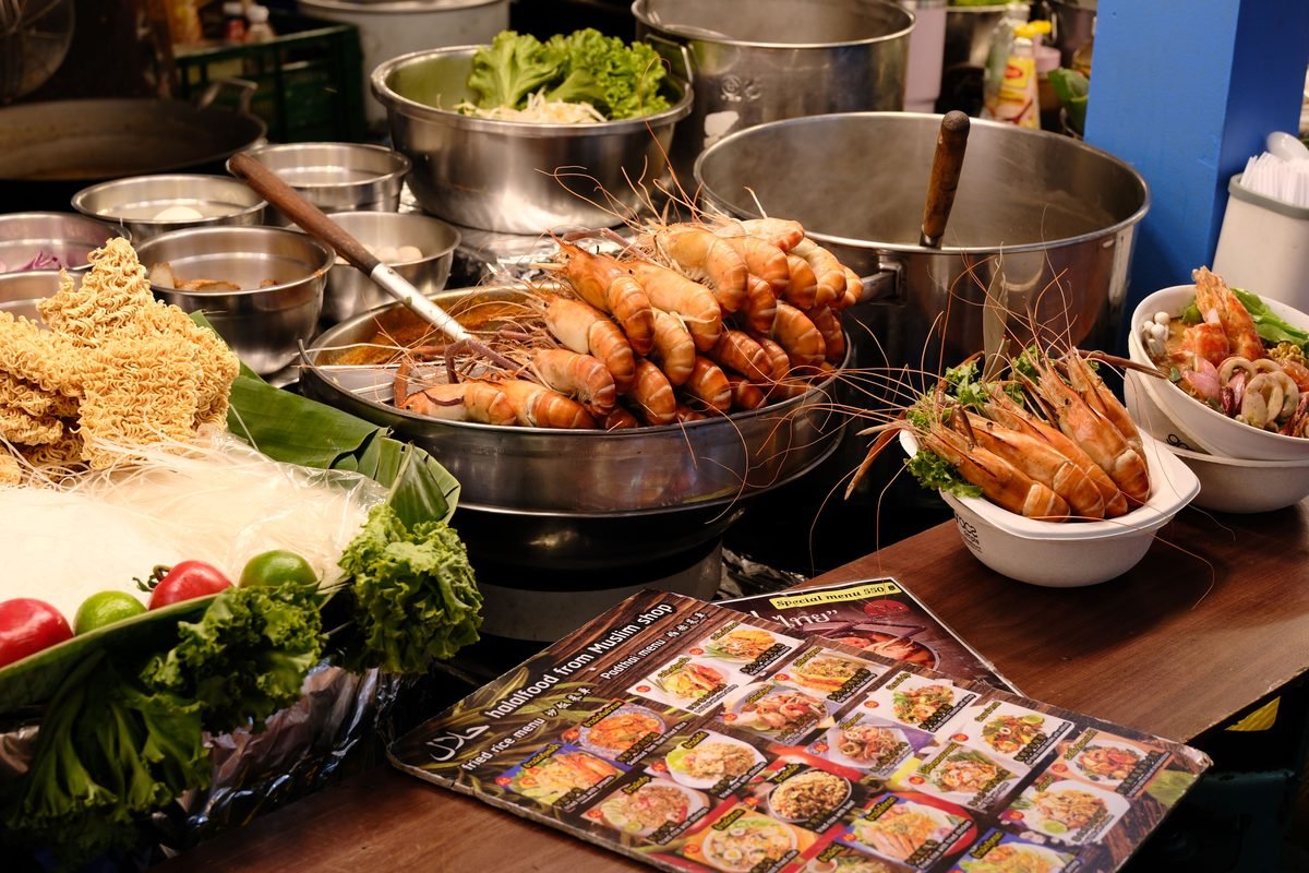 Street food stall display featuring fresh prawns and ingredients