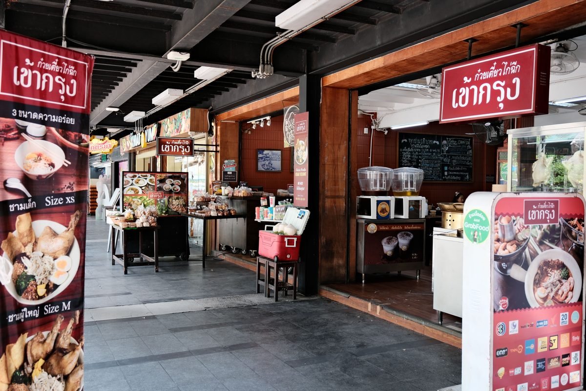 Street food restaurant storefront with menu and signage
