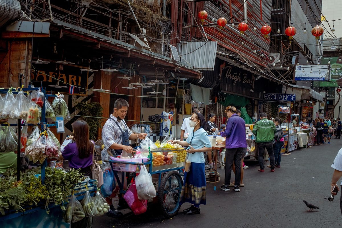 Bustling street market with vendors and shoppers