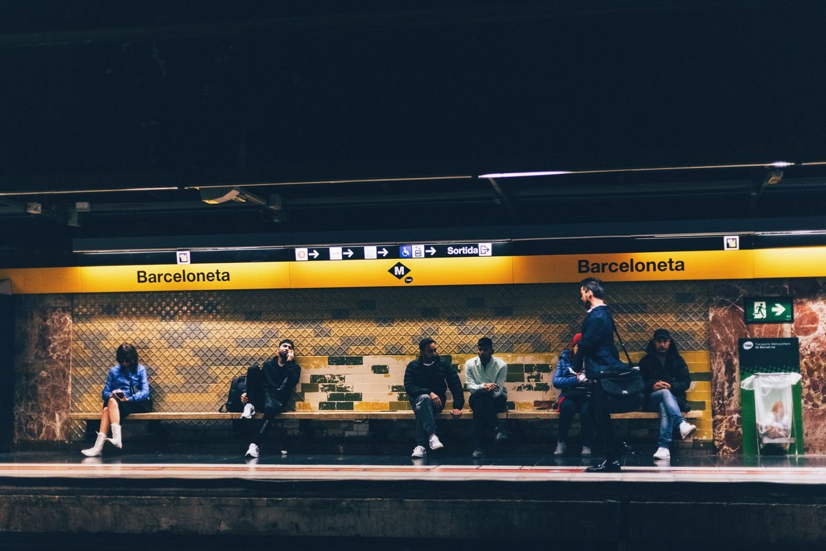 Commuters waiting on the platform at Barceloneta station in Barcelona.