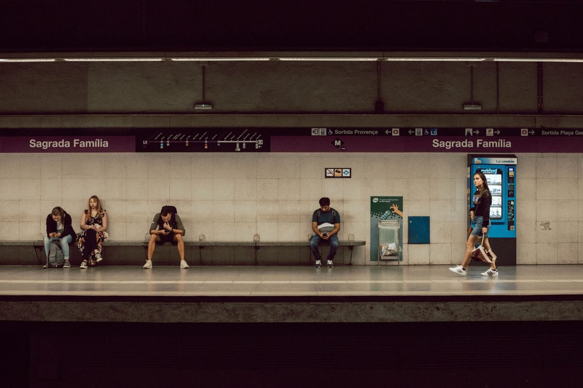 Passengers waiting on the subway platform at Sagrada Familia station in Barcelona.