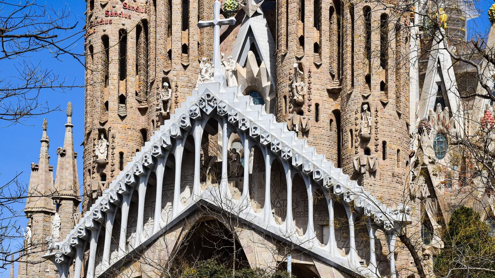 Close-up architectural view of the Sagrada Familia facade in Barcelona with ornate details.