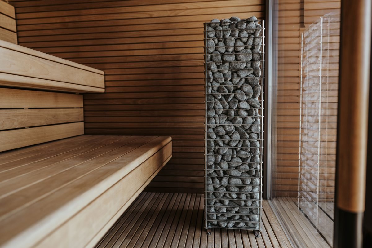 Interior of a wooden sauna with stacked stone heater