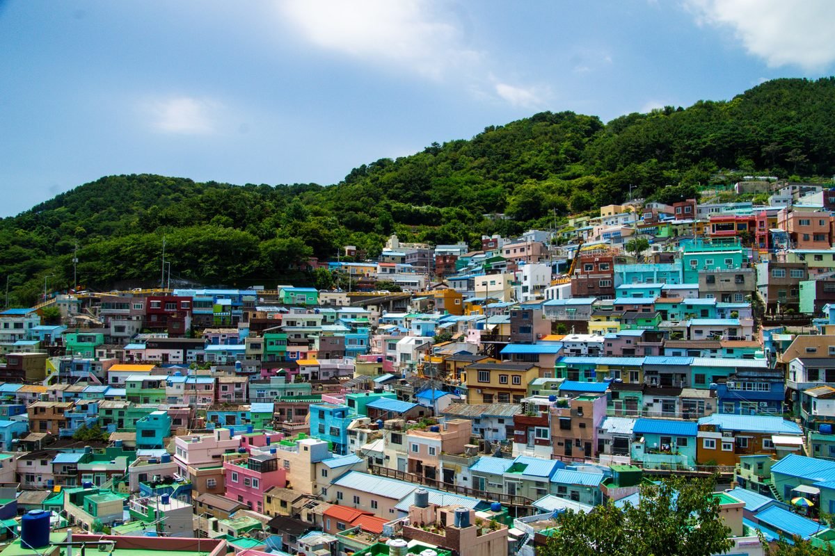 Vibrant residential buildings painted in various bright pastel colors on a slope