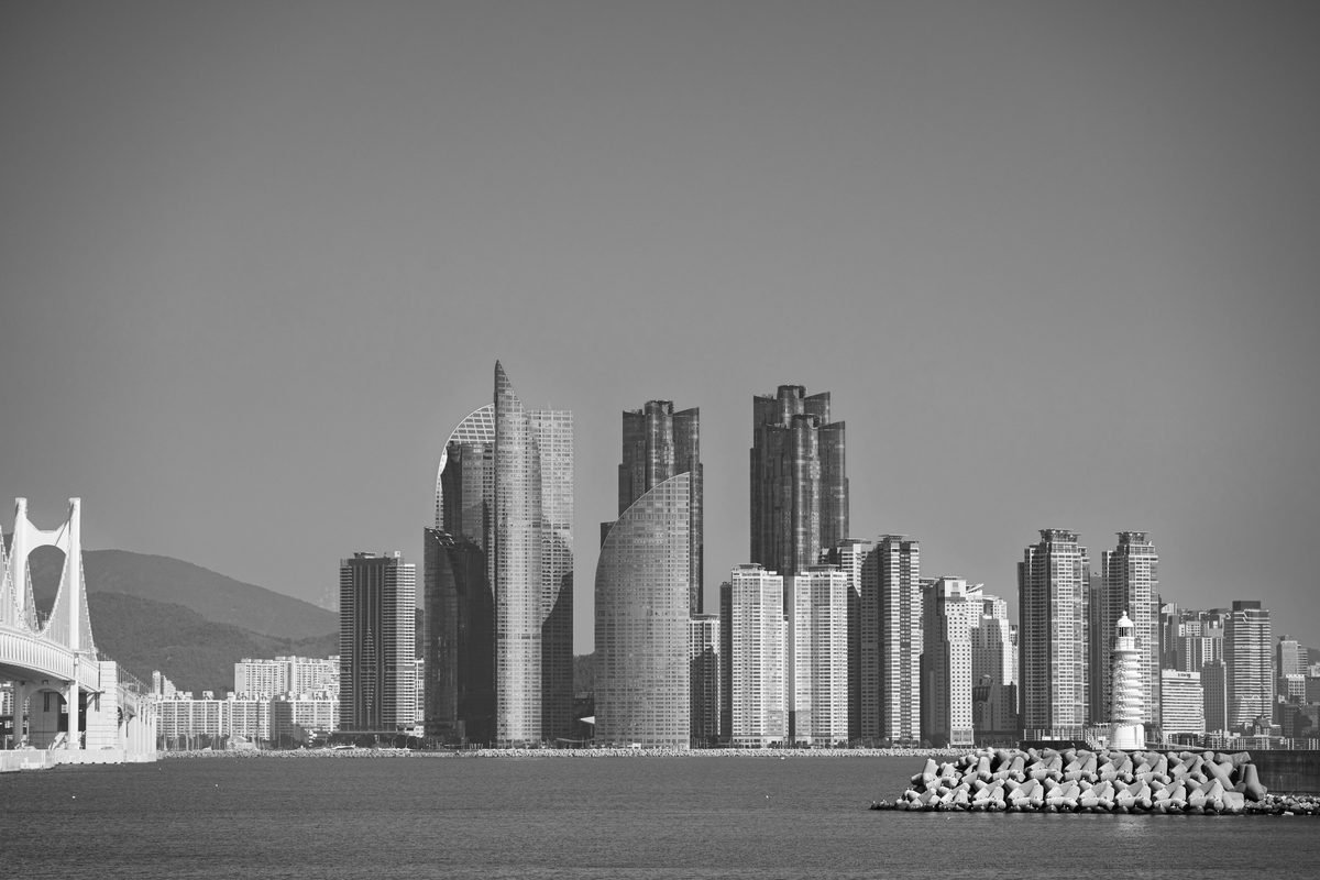 Monochrome view of Busan modern skyscrapers and coastal bridge