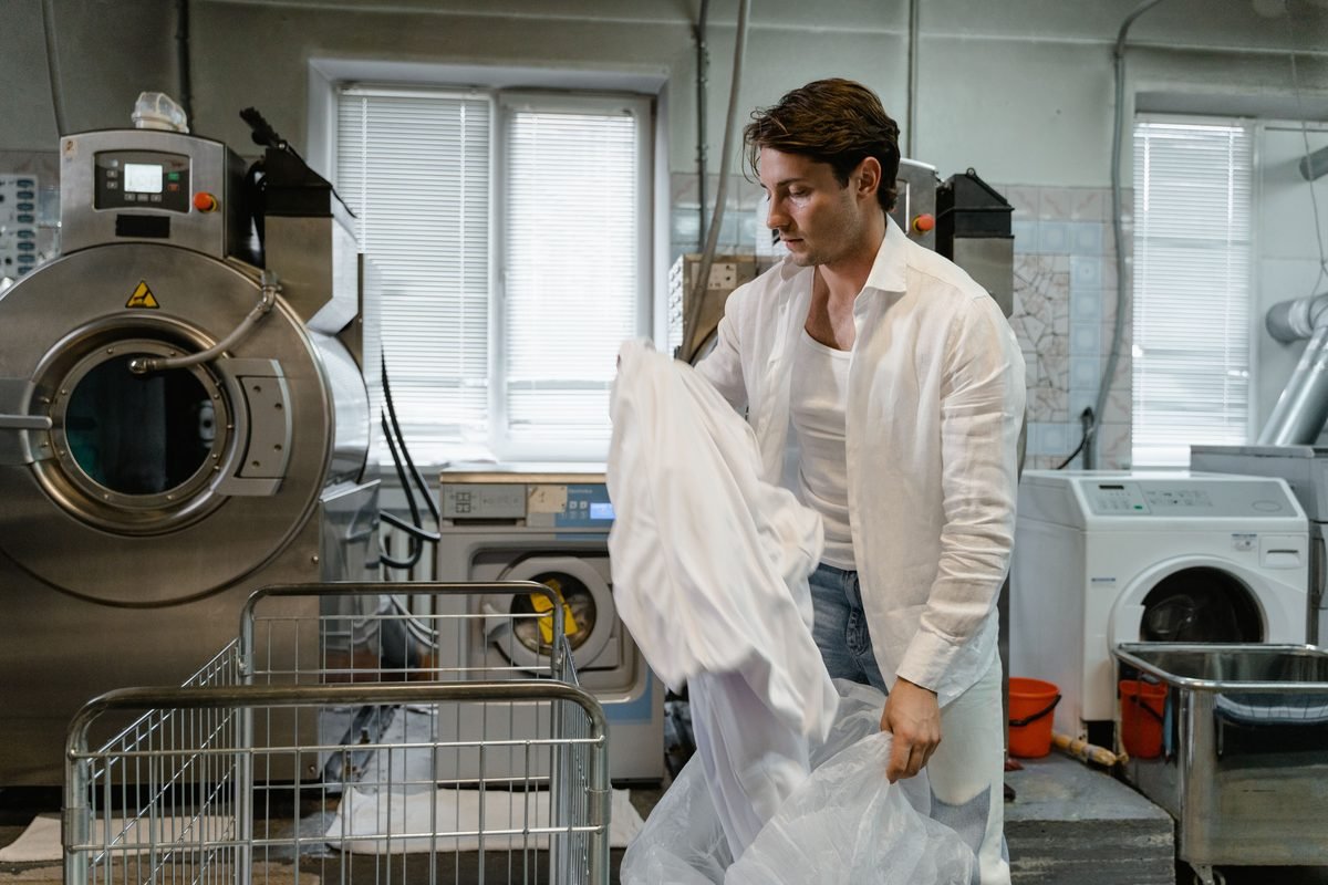 Man organizing laundry in a modern industrial facility