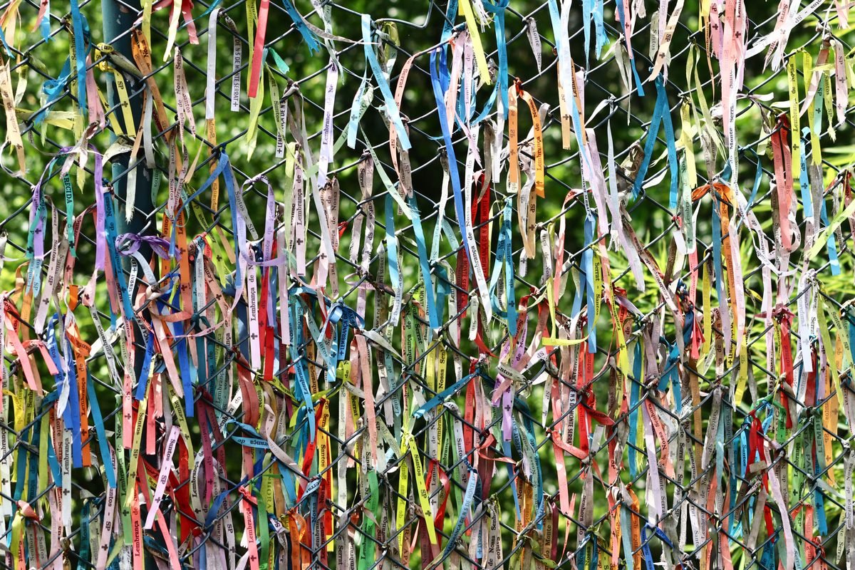 Vibrant colored ribbons decorate a wire fence display.