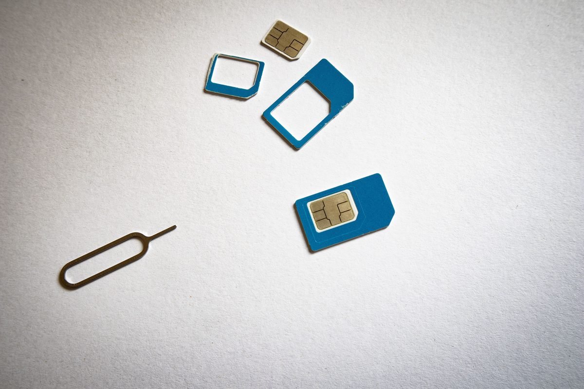 Close-up of physical SIM cards and an ejector tool.