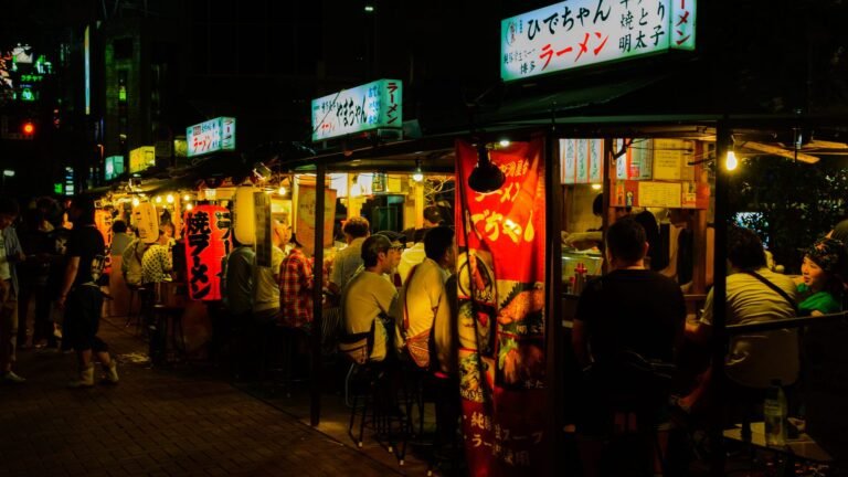 Nakasu Yatai food stalls operating at night along the river in Fukuoka.