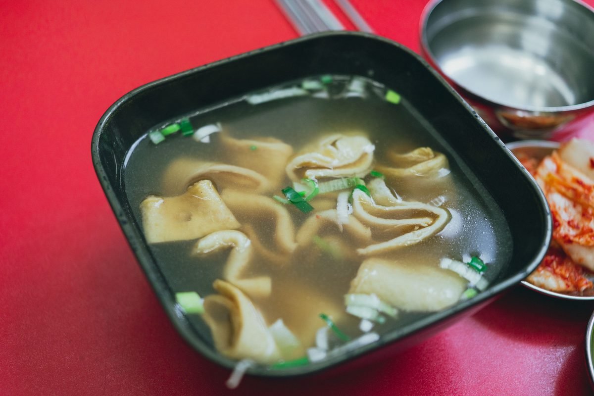 Appetizing Korean fish cake soup served with kimchi