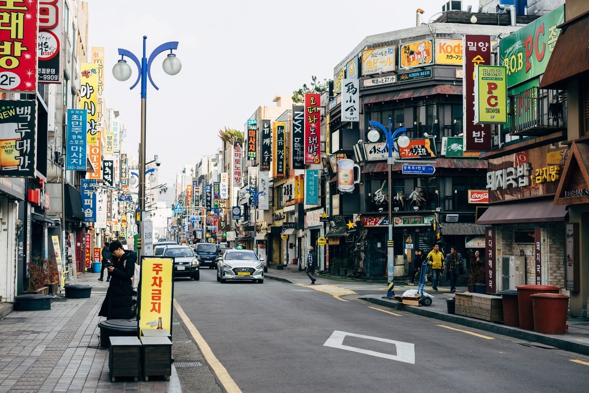 Colorful city street in Busan with bustling activity and diverse signage