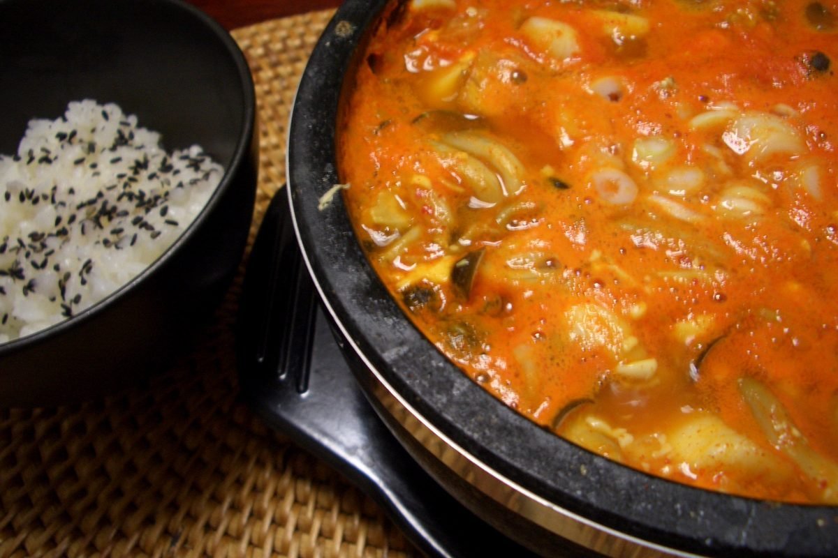 Bubbling sundubu-jjigae, Korean soft tofu stew, served with rice