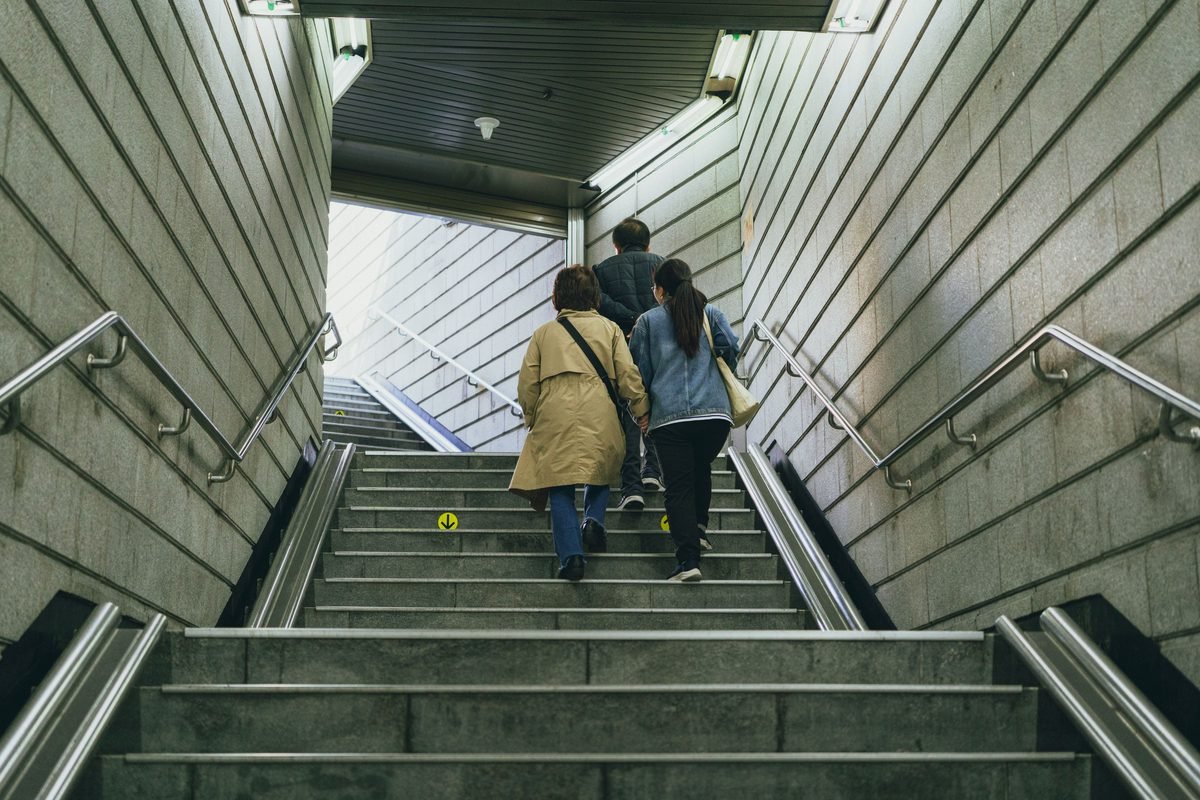 Adults climbing subway stairs in Seoul