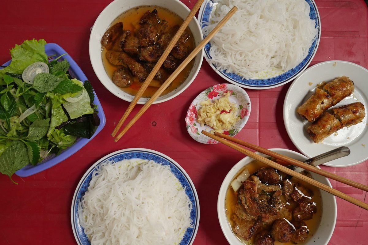 Bun cha in Hanoi: grilled pork in broth, rice vermicelli, herbs and crab spring rolls