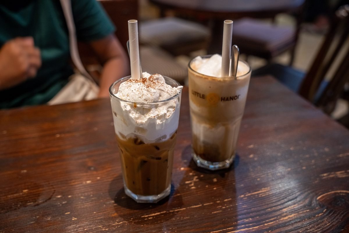 Tall glasses of iced coffee topped with thick whipped cream