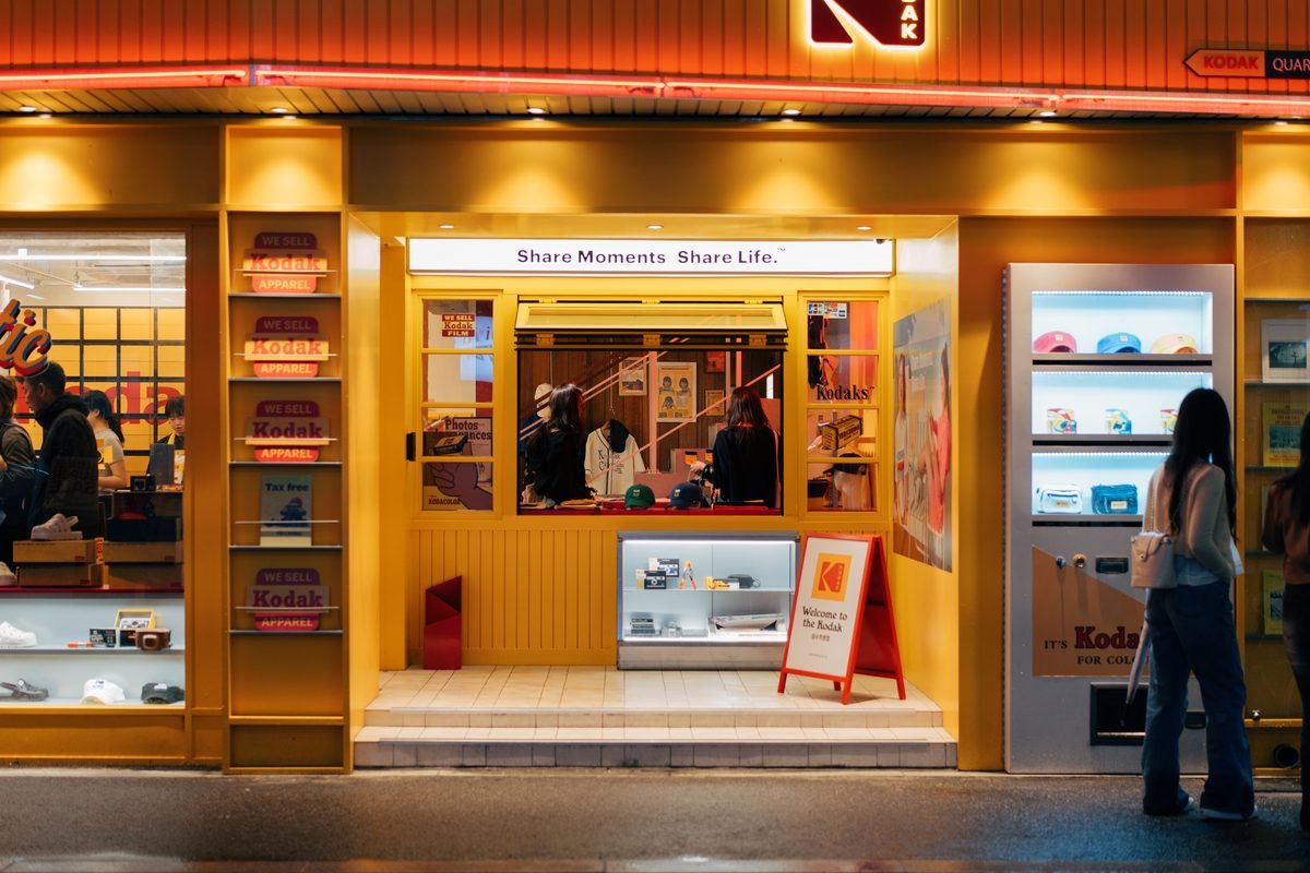 Vibrant yellow storefront of a shop at night