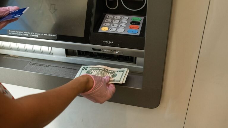 Person withdrawing cash from an ATM machine