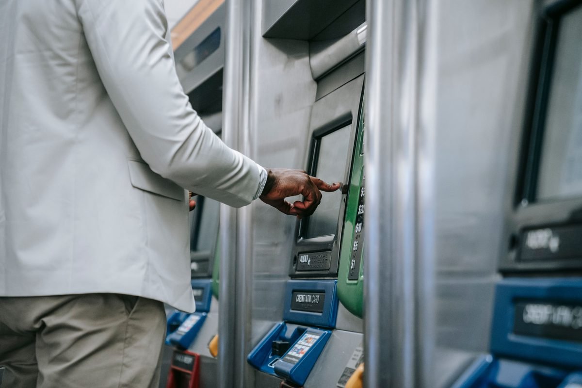 Person using a self-service ticket and ATM machine