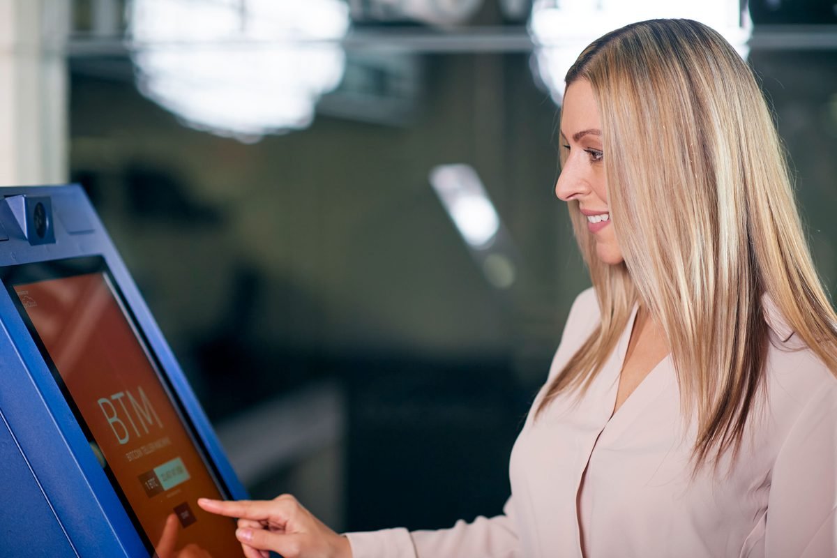 Woman interacting with a digital ATM screen