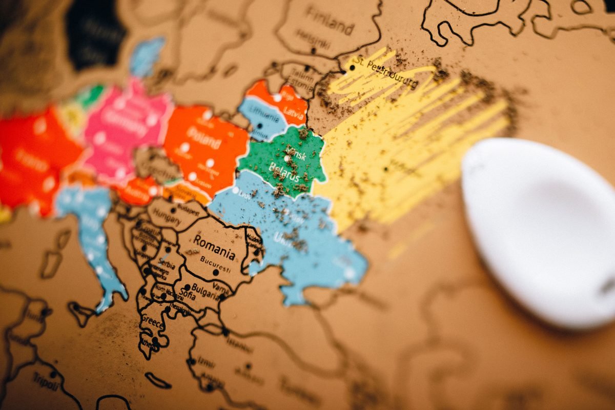 Scratch-off world map highlighting European countries for travel planning.