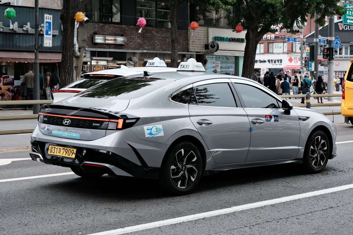 Hyundai taxi driving through a street in Seoul.