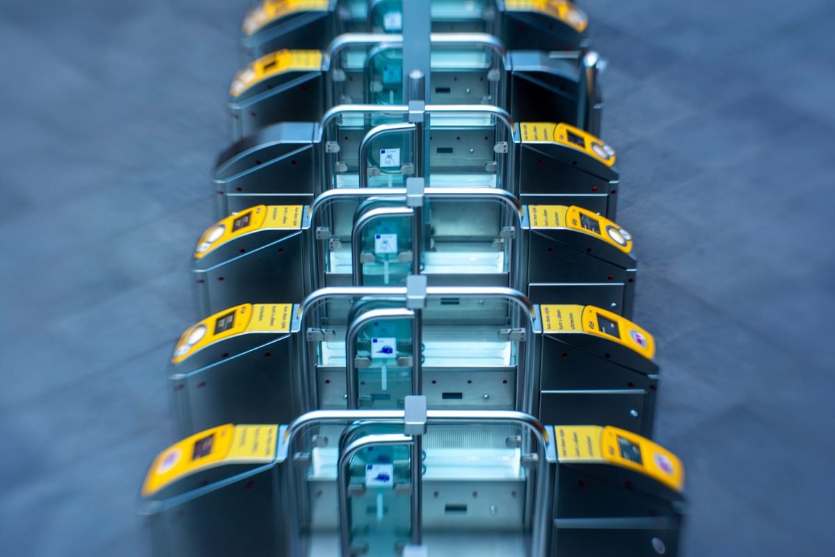 Elevated view of modern subway turnstiles in a station.