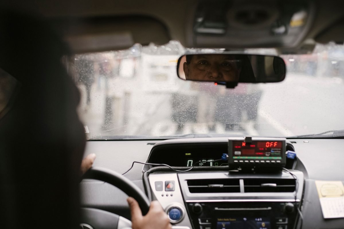Driver's view with a taxi meter inside a vehicle.