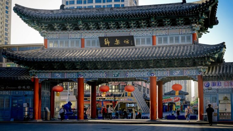 Traditional Chinese gate with red pillars and glowing lanterns in Incheon.