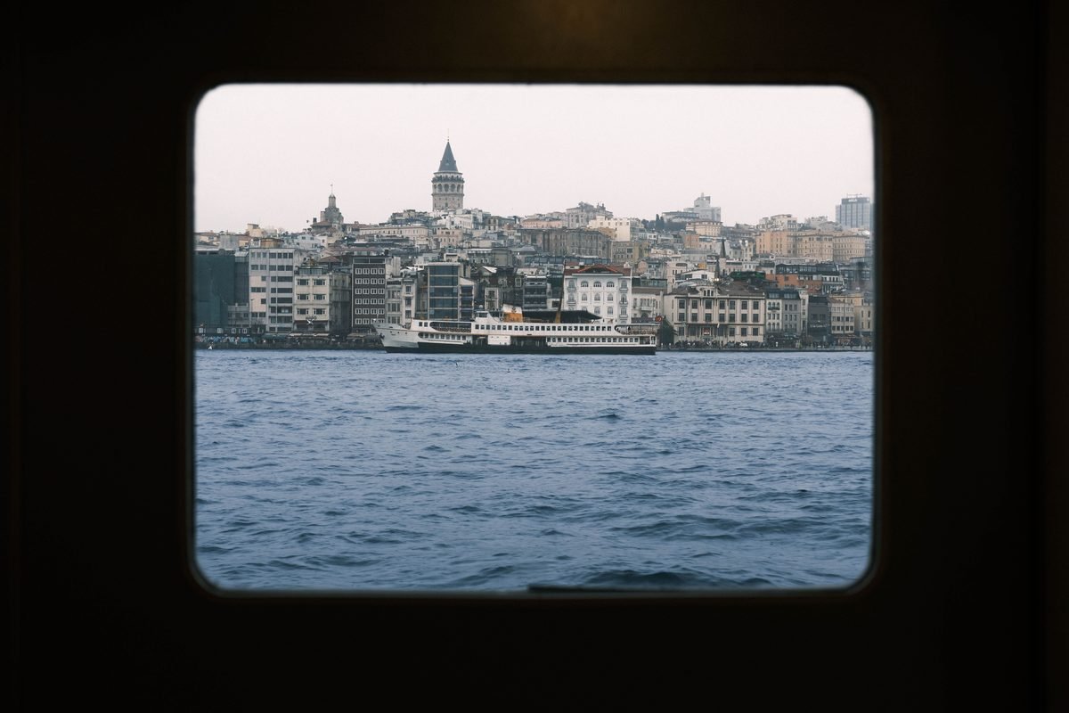 Istanbul skyline and Galata Tower viewed through a ferry window.