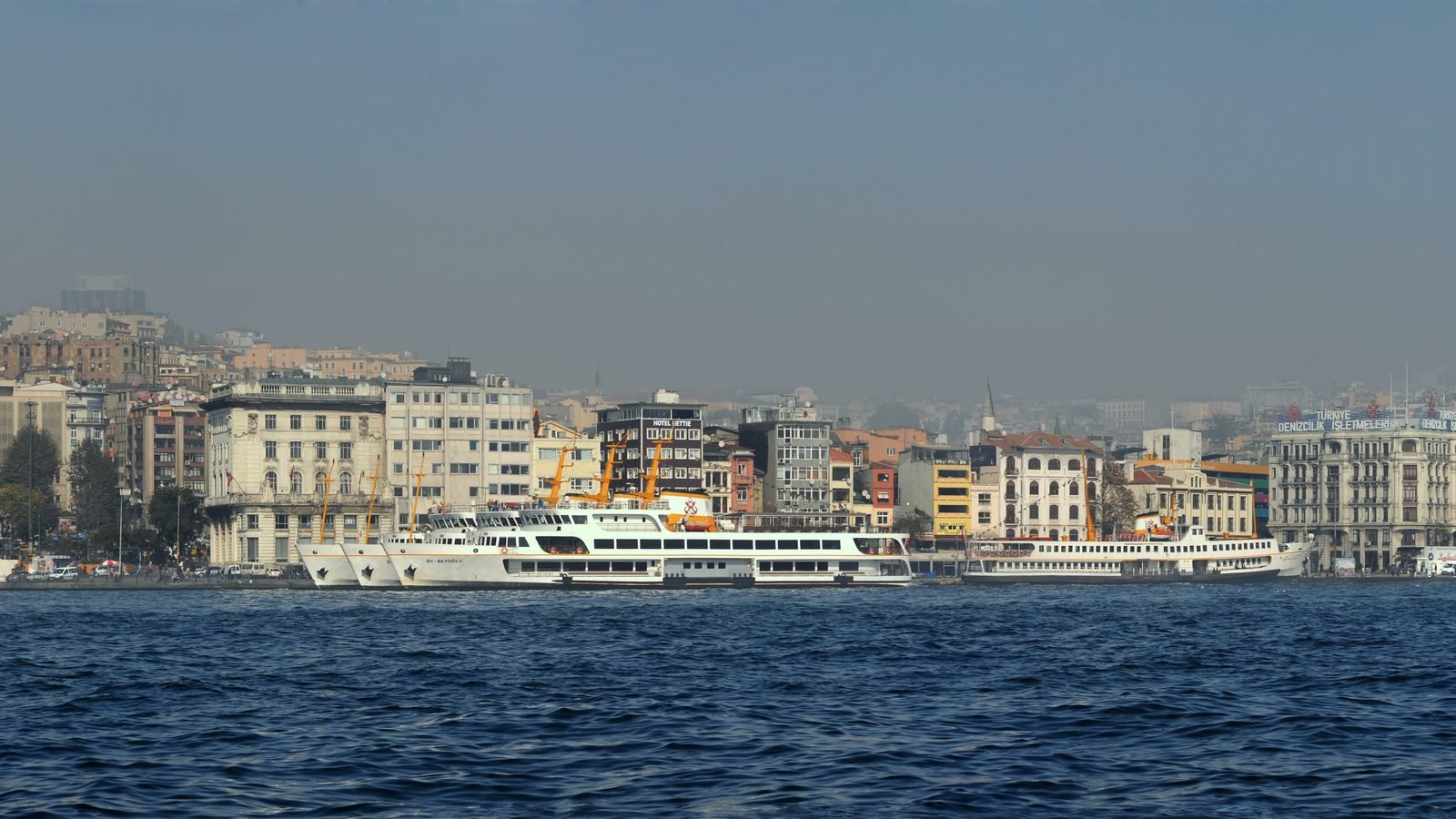 Panoramic view of Istanbul under fog with Galata Tower in the center.