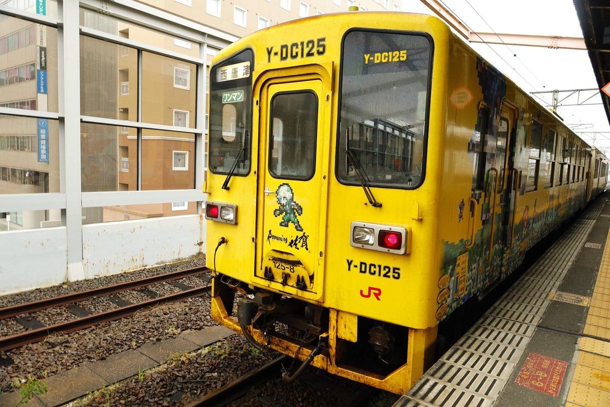 Vibrant yellow train at Nishi-Karatsu Station in Saga