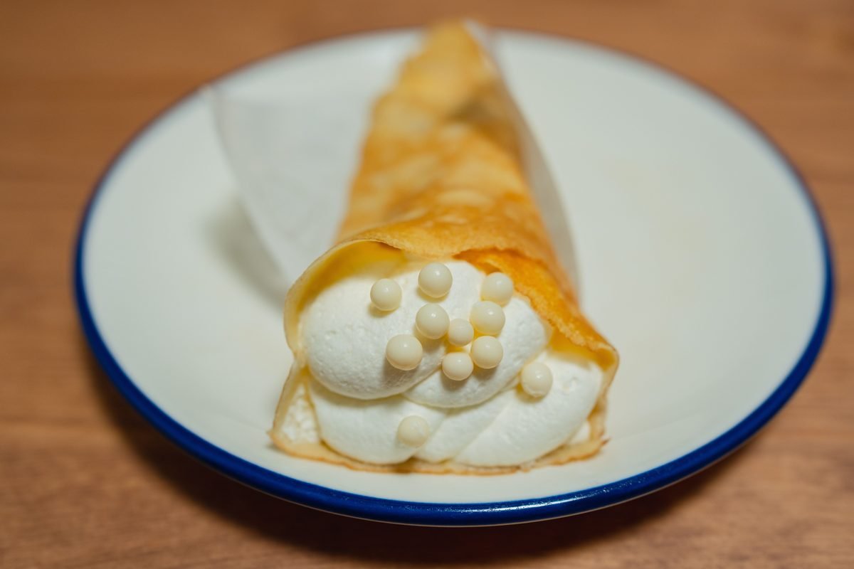 Japanese crepe topped with white chocolate pearls on a plate