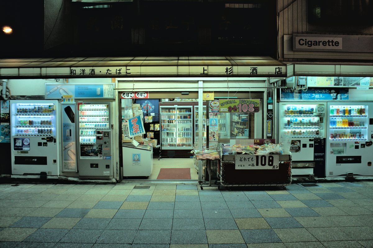 Japanese convenience store at night in Osaka with vending machines