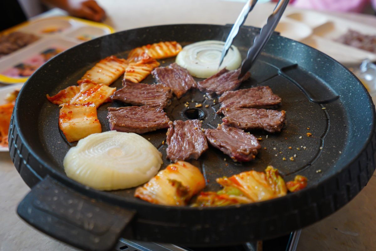 Delicious Korean barbecue featuring beef and onions on a hot plate