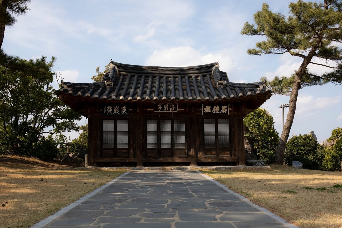 Traditional Korean Hanok building nestled among green trees