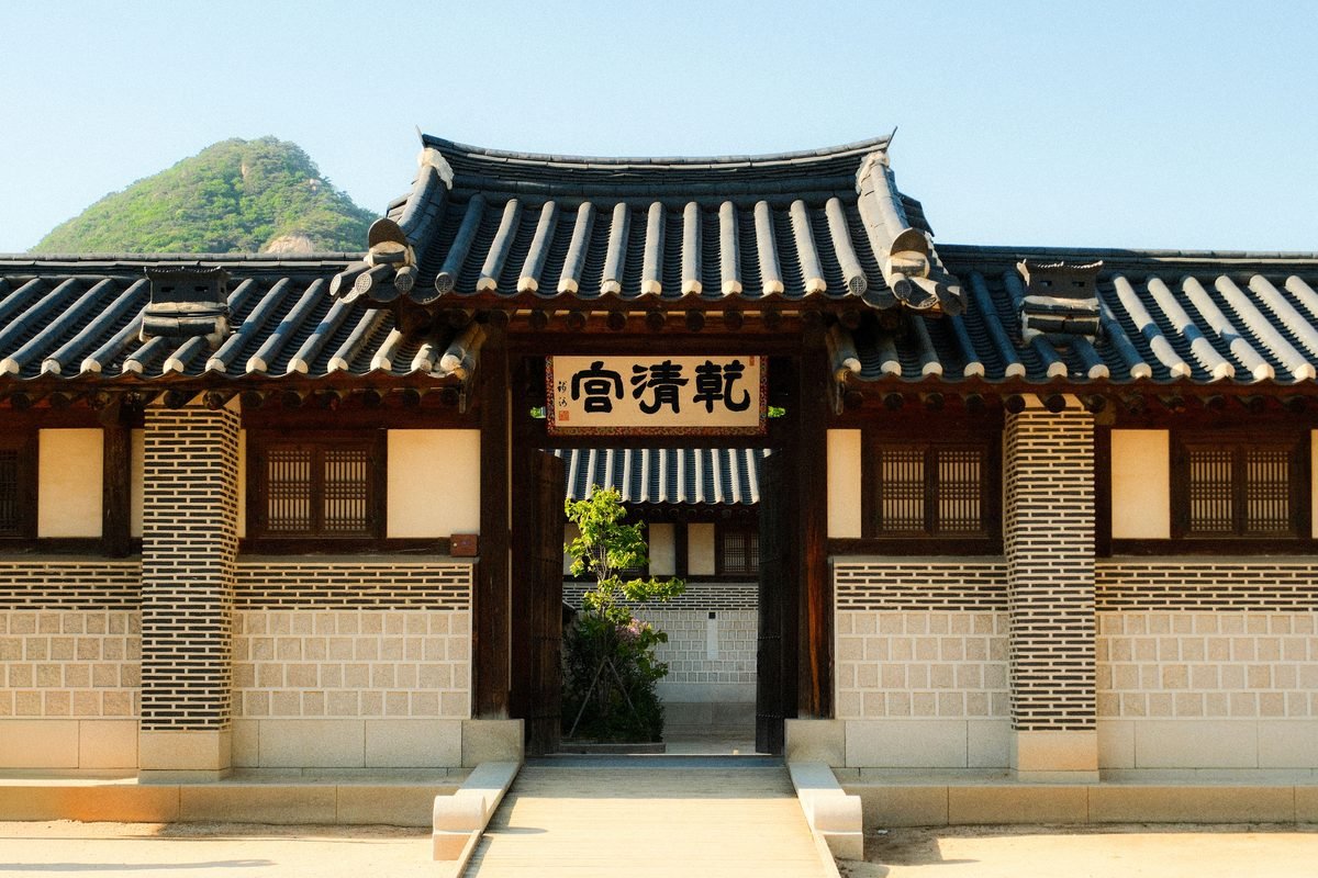 Traditional Korean building gate with mountain backdrop