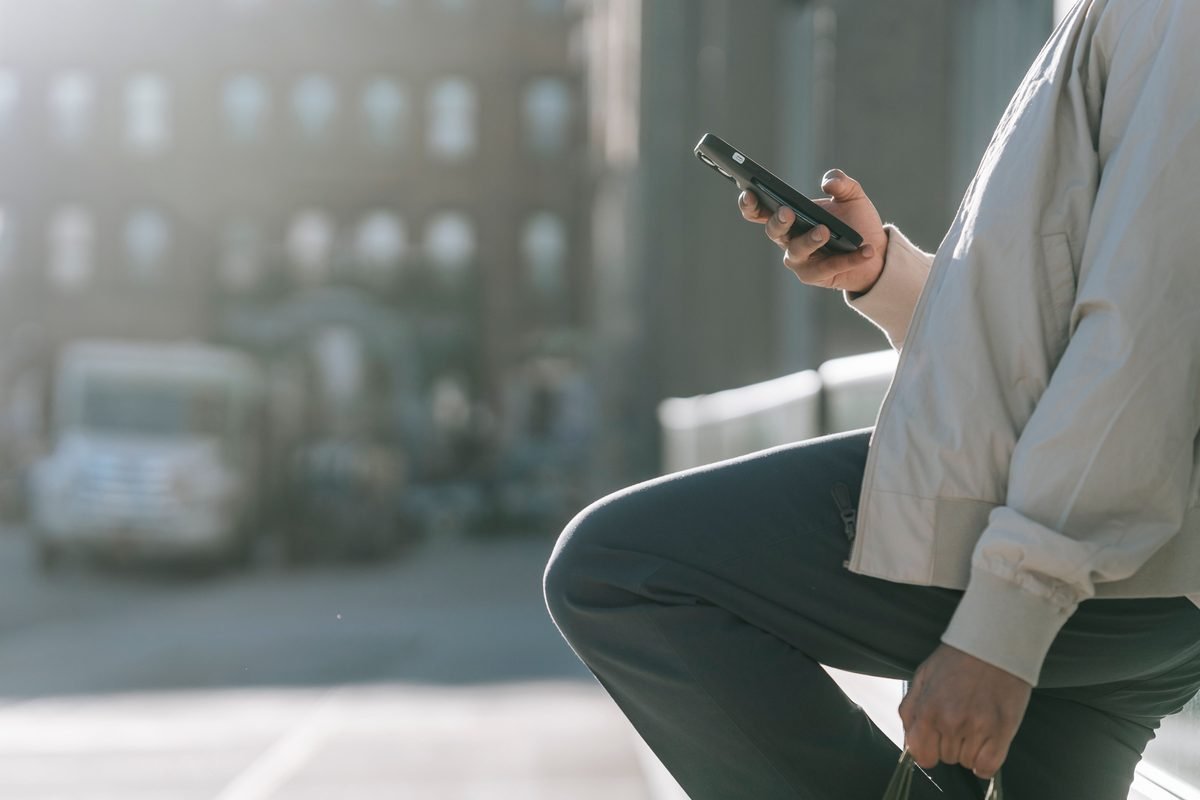 Person using a smartphone on an urban street
