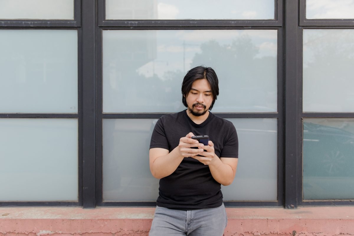 Person looking at a mobile phone outdoors
