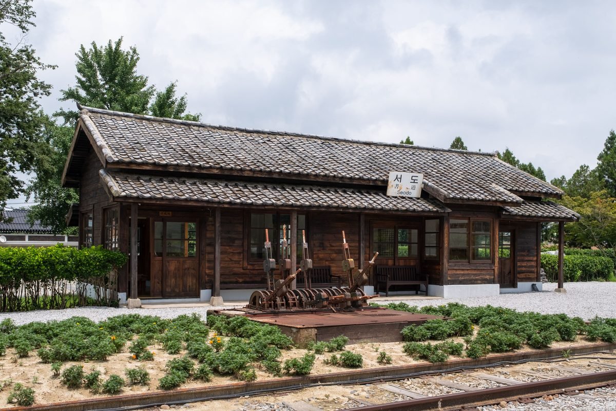 Rustic wooden railway station building with tiled roof