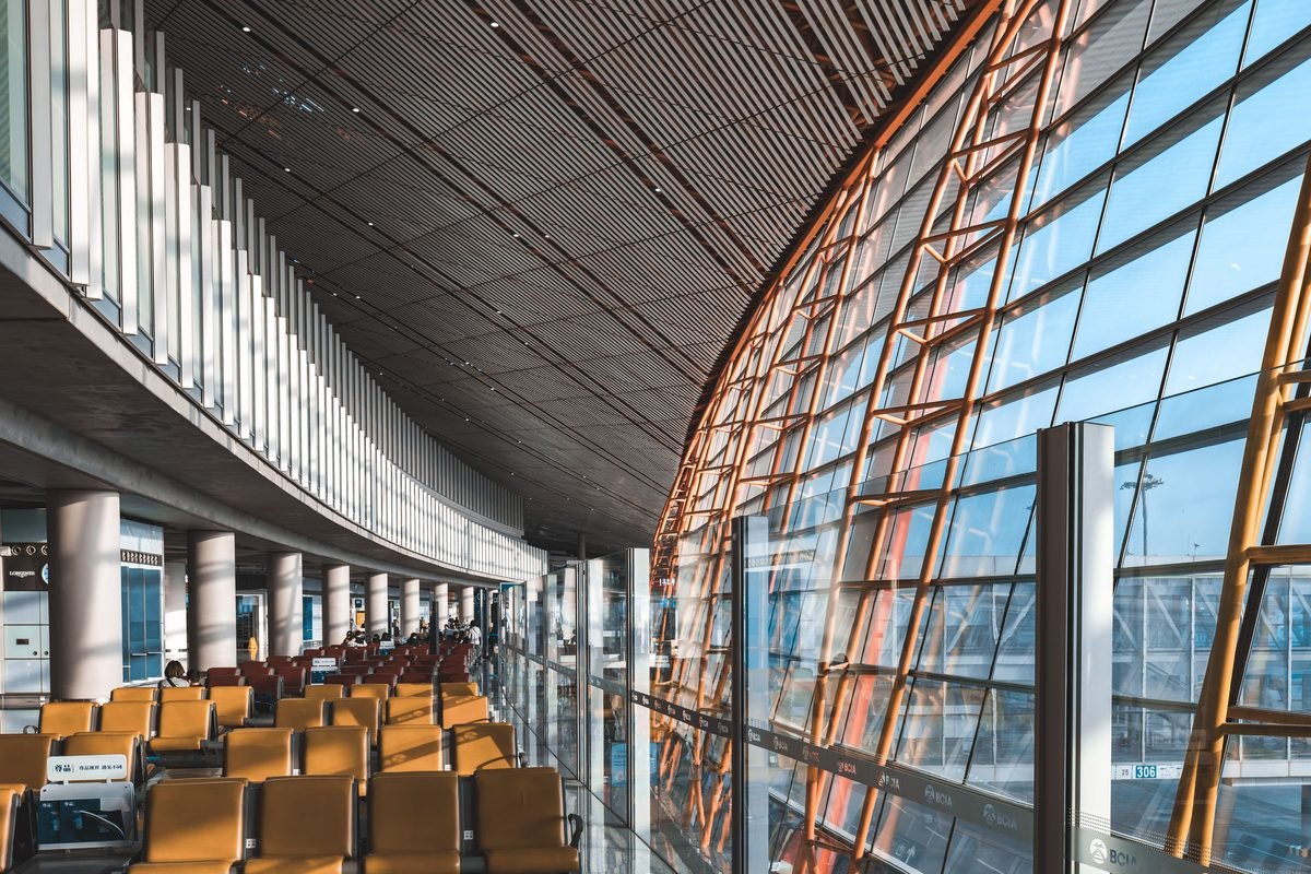 Interior view of a modern airport terminal with large windows