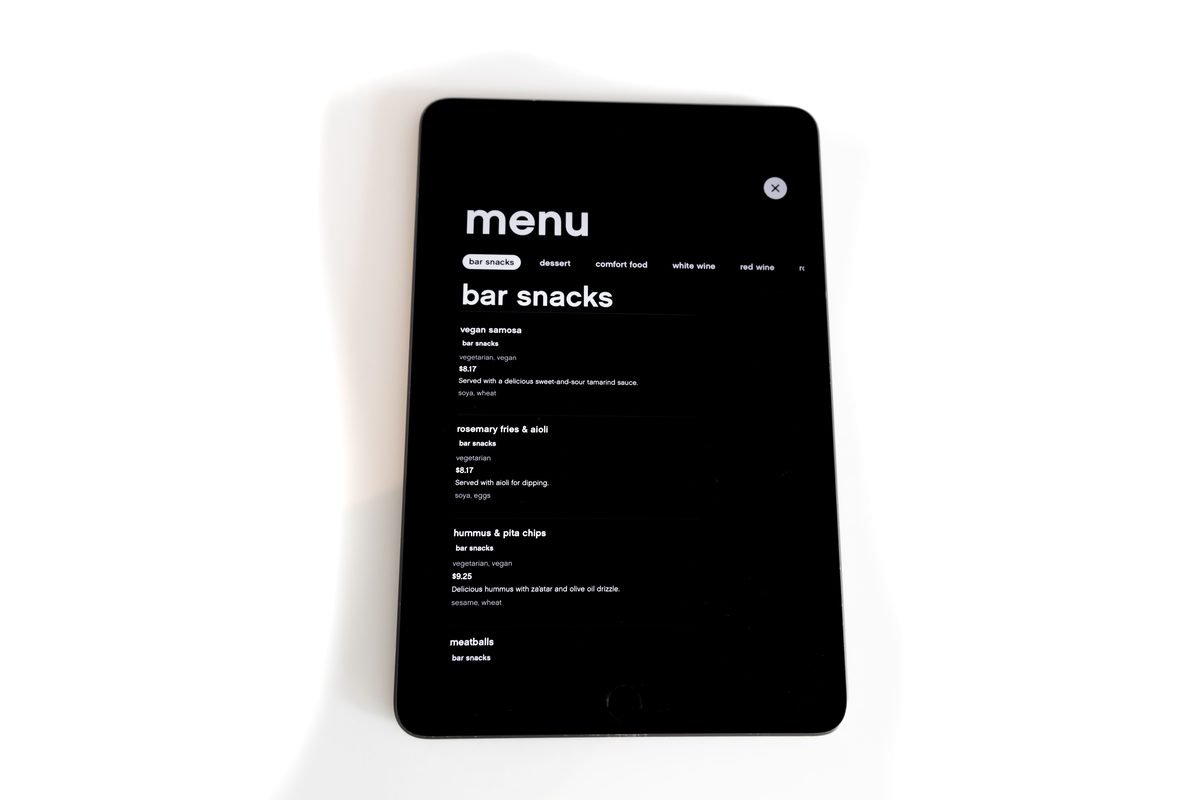 Tablet displaying a digital menu for bar snacks in a minimalistic style