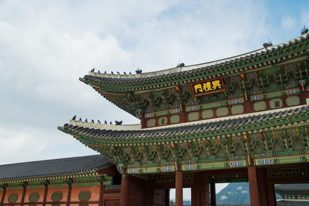 Ornate traditional Korean roof architecture at Gyeongbokgung Palace in Seoul.